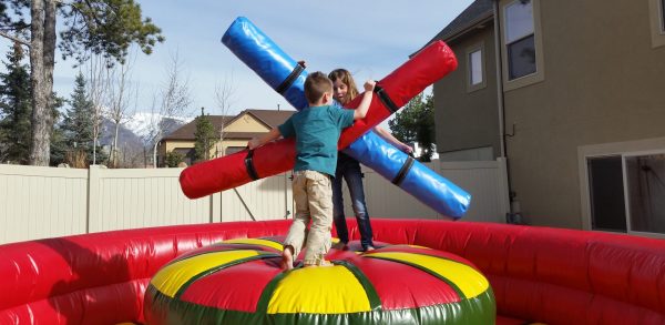 2 kids with inflatable jousting